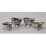 A Matched Pair of Victorian Silver Salts with fluted decoration, London 1876 and one other and