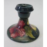 A Moorcroft pottery candlestick with impressed Marks and paper label to Base