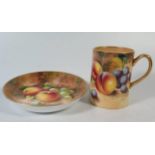 A Royal Worcester coffee can and saucer decorated with fruit signed Roberts