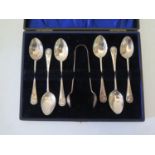 A cased set of silver teaspoons and sugar tong