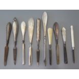 A collection of silver mother of pearl and Bone handled manicure items and four silver handled