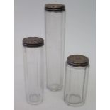 A set of three silver top slice cut glass dressing table pots