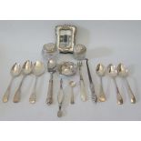 A small silver photograph frame, two silver dressing table pots cutlery etc