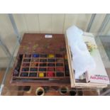 A pallet of watercolour paints and oils