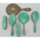 A George V silver and green Guilloche enamel backed 5 part mirror and brush set and one other