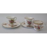 A Royal Worcester hand-painted trio and 2 cups