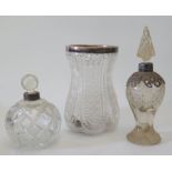 A silver collared cut crystal vase and two others