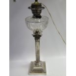 A Large Silver Plated Corinthian Column Paraffin Lamp with cut glass reservoir