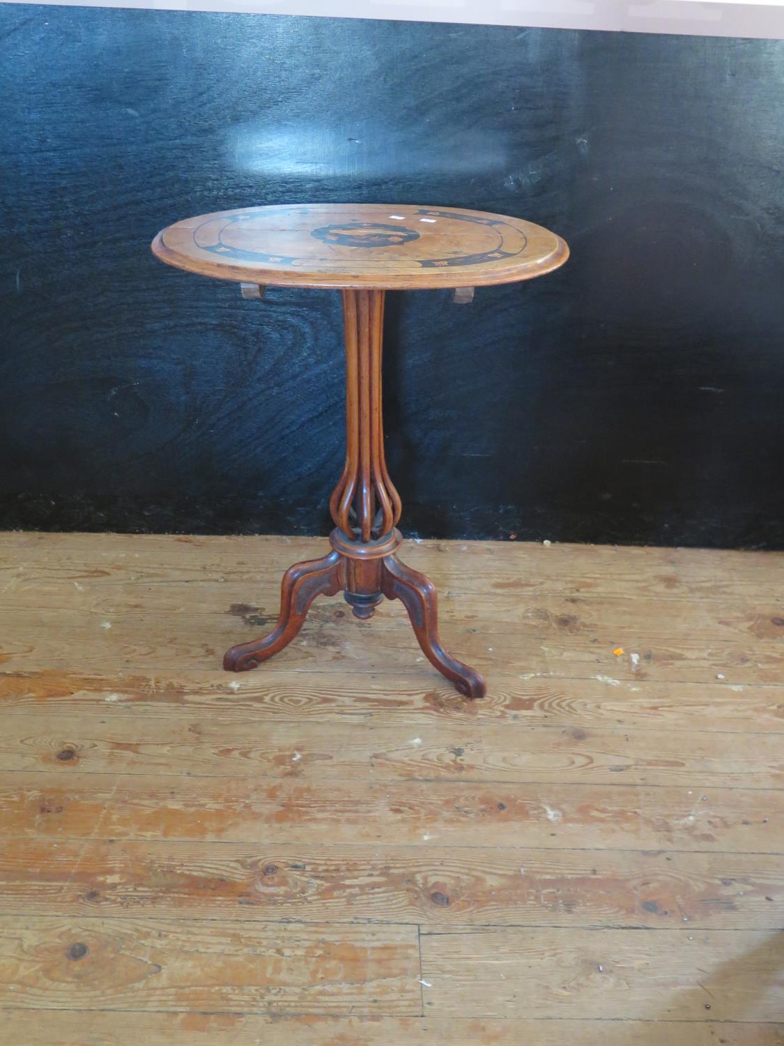 An Unusual 19th Century Italian Occasional Table with marquetry inlaid top and resting on an eight