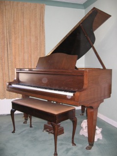 Blüthner (c1935) A 5ft grand piano in a walnut case on square tapered legs.