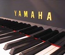 Yamaha (c1976) A Model U1 upright piano in a bright ebonised case.