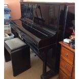 Steinway (c1893) An upright piano in an ebonised case together with an ebonised stool with storage