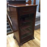 Music Cabinet An Edwardian carved mahogany music cabinet enclosed by a glazed panelled door