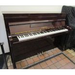 Yamaha (c1996) A Model M110 upright piano in a bright mahogany case.