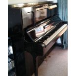 Steinway (c1939) A Model K upright piano in an ebonised case; together with a stool.