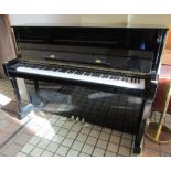 Kawai (c2003) A Model KX-15 upright piano in a bright ebonised case.