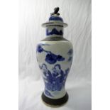 A late 19th century/early 20th century Chinese blue and white crackle glaze lidded vase,