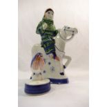 A Rye Pottery figure of a woman on a horse, 21.