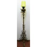 An ornate Victorian standard oil lamp, raised on three legs with scroll,