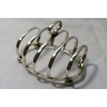 An Art Deco toast rack, or squat form, Birmingham 1939, 9.5cm long x 6.2cm high, 2.58ozt, 80.