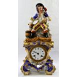 A 19th century French porcelain mantle clock with figural surmount, the movement striking on a bell,