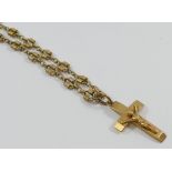 A nine carat gold chain with fancy links and barrel clasp and a crucifix pendant,