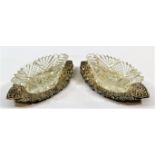 A pair of Victorian cut glass oval salts on silver stands,