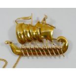 A yellow metal brooch in the form of a Viking longship, stamped '750', 4.9cm long, 11.