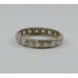 A diamond eternity ring, the 19 round stones of various cuts, combined weight approximately 1 carat,