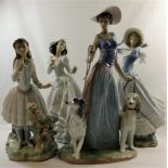 Four Lladro figures of ladies, the tallest walking two dogs,