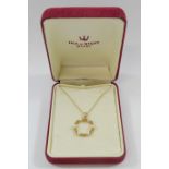 A 9 carat gold circular openwork pendant set with six small cultured pearls, 1.