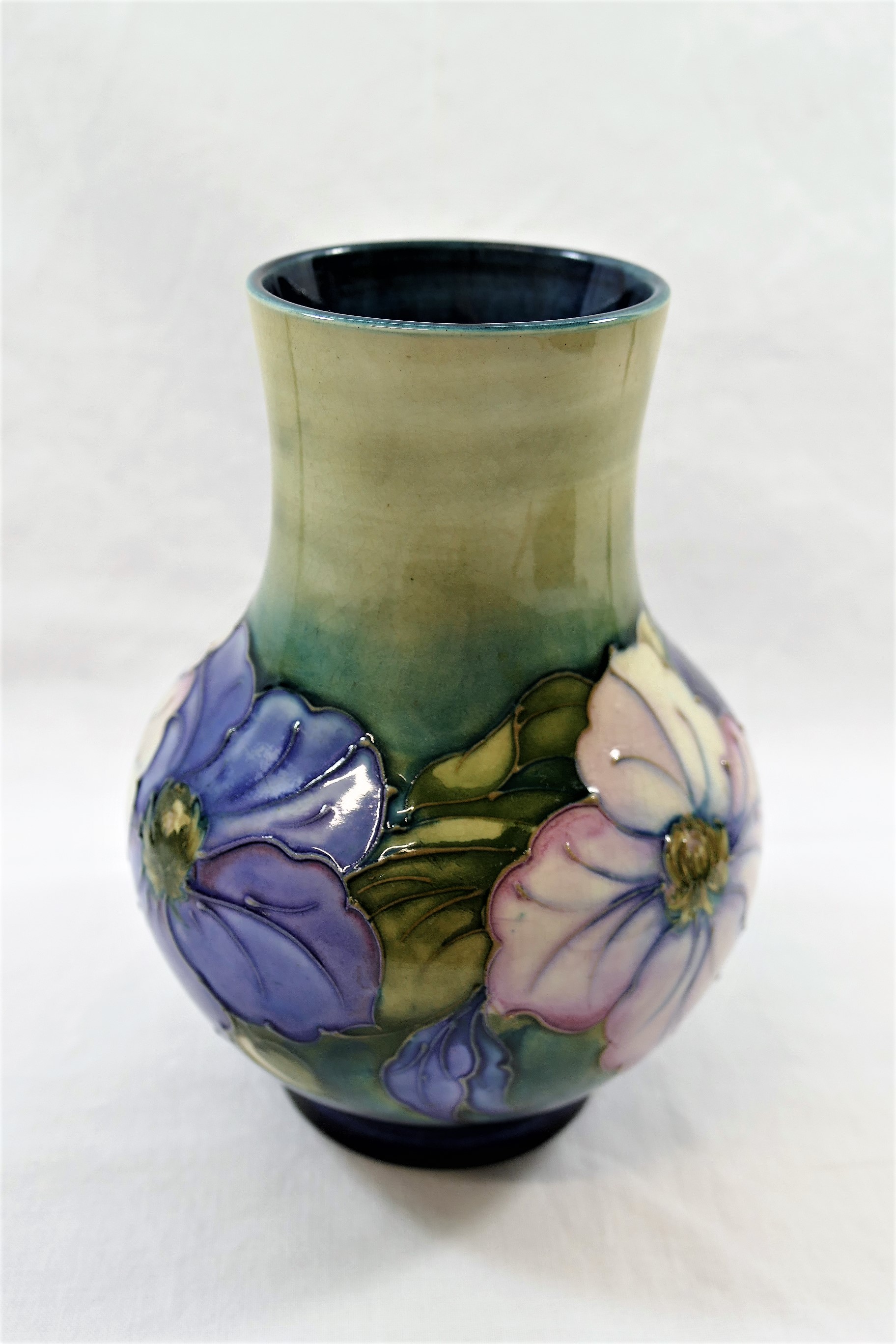 A Moorcroft 'Clematis' pattern tubeline decorated baluster-shaped vase by Walter Moorcroft,