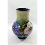 A Moorcroft 'Clematis' pattern tubeline decorated baluster-shaped vase by Walter Moorcroft,