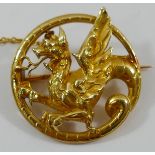 A yellow metal circular dragon brooch, 2.