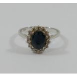 An 18 carat gold sapphire and diamond oval cluster ring,