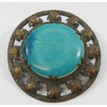 A large circular Ruskin pottery brooch, the turquoise glazed panel marked 'RUSKIN' to the reverse,