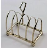 A George V five bar silver toast rack, London 1936, 7.4cm long, 1.62ozt, 50.