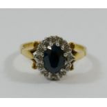 An 18 carat gold sapphire and diamond oval cluster ring,
