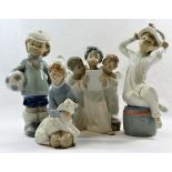 Four Lladro porcelain figures and figural groups, the tallest of a boy with a football, 21cm high,