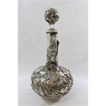 A Japanese silver overlaid decanter, with pierced and embossed iris decoration, some damage,