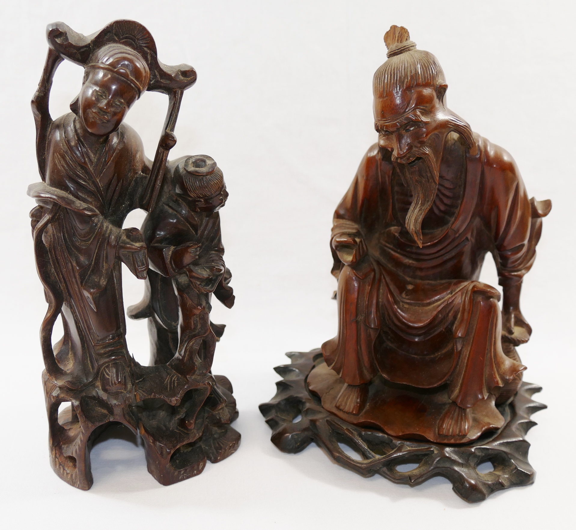 A Chinese hardwood carving of an seated elderly man, possibly a fisherman, 19cm high,