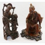 A Chinese hardwood carving of an seated elderly man, possibly a fisherman, 19cm high,