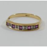 A yellow metal ruby and diamond half eternity ring,