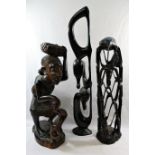 A collection of nine African carvings and sculptures including a pair of masks and a wooden club,