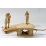 A 19th century Indian Company school ivory figural group carrying a Sedan chair, 13.2cm long x 4.