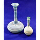 Two Roman style glass vases, the fine striated blue ground glass with matt finish to the exterior,