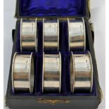 An Edwardian set of six silver napkin rings, Chester 1906, 1.9cm wide, combined weight 4.