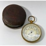 A pocket barometer by E R Watts and Son, London, in gilt metal case, 5cm diameter,