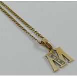 A 9 carat gold initial pendant 'M' set with three small eight-cut diamonds, London 1979,