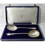 A pair of late Victorian silver serving spoons, London 1899, with cast and engraved decoration, 21.
